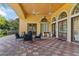 Inviting outdoor patio with comfortable seating, ceiling fans, and a tiled floor, perfect for gatherings at 1205 Butterfly Orchid Rd, Davenport, FL 33837