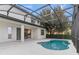 Beautiful backyard pool and outdoor entertaining area featuring direct kitchen access at 1205 Butterfly Orchid Rd, Davenport, FL 33837