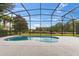 The screened-in pool offers a private retreat with views of lush greenery and a serene pond at 1205 Butterfly Orchid Rd, Davenport, FL 33837