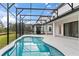 Beautiful backyard pool is surrounded by a screened enclosure and manicured lawn at 1205 Butterfly Orchid Rd, Davenport, FL 33837