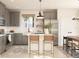 Bright kitchen with gray cabinets, stainless steel appliances, an island with seating, and an eat-in dining area at 13252 Sw 85Th Cir # 58, Ocala, FL 34473