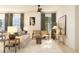 Cozy living room featuring a comfortable sofa, patterned pillows, stylish furniture, and large windows at 13252 Sw 85Th Cir # 58, Ocala, FL 34473