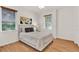 Bedroom with a double window, wood-look flooring, a ceiling fan, and light gray furnishings at 1389 Longley Place, Deland, FL 32724