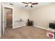 Spacious carpeted bedroom features neutral walls, a ceiling fan, and natural light at 14486 Sunbridge Cir, Winter Garden, FL 34787