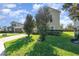 Elegant two-story home with a paved driveway, manicured lawn, and mature trees at 14486 Sunbridge Cir, Winter Garden, FL 34787