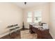 Home office with hardwood floors, a large desk, and natural light from two windows at 14486 Sunbridge Cir, Winter Garden, FL 34787