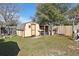Backyard featuring a storage shed and a swing set, ideal for outdoor recreation and storage needs at 14884 Sw 35Th Cir, Ocala, FL 34473