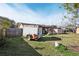 Large grassy backyard with storage sheds and a trailer offering ample outdoor space and storage solutions at 14884 Sw 35Th Cir, Ocala, FL 34473