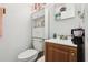 Bathroom featuring a toilet, vanity, and white shelving unit at 14884 Sw 35Th Cir, Ocala, FL 34473