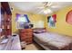 A small bedroom with yellow walls, simple decor, and tile flooring at 14884 Sw 35Th Cir, Ocala, FL 34473