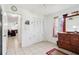Bedroom with tile flooring, wooden dresser, and closet doors at 14884 Sw 35Th Cir, Ocala, FL 34473