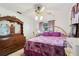 Cozy bedroom with purple accents, tile flooring, and a vintage dresser at 14884 Sw 35Th Cir, Ocala, FL 34473