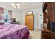 Bedroom with ceiling fan, tile flooring, and a wooden wardrobe at 14884 Sw 35Th Cir, Ocala, FL 34473