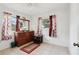 Bedroom featuring a dresser, tile flooring, and patterned curtains at 14884 Sw 35Th Cir, Ocala, FL 34473