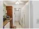 Narrow kitchen featuring wood cabinets, tile flooring, and white appliances at 14884 Sw 35Th Cir, Ocala, FL 34473