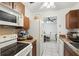 A bright kitchen with white appliances and adjacent dining area, perfect for Gathering meals at 14884 Sw 35Th Cir, Ocala, FL 34473