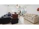 Comfortable living room with tile flooring, a ceiling fan, and ample seating arrangements at 14884 Sw 35Th Cir, Ocala, FL 34473