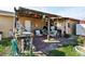 Covered patio with outdoor seating and a storage area at 14884 Sw 35Th Cir, Ocala, FL 34473