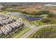 An aerial view of the houses, landscaping, and neighborhood with a view of a pond and nature at 17087 Wynford Ln, Winter Garden, FL 34787