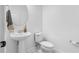Half bath featuring a pedestal sink and toilet at 17087 Wynford Ln, Winter Garden, FL 34787