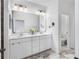 Bathroom featuring double sink vanity and marble floors at 17087 Wynford Ln, Winter Garden, FL 34787
