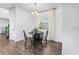 Dining room featuring a round table with black chairs and wood flooring at 17087 Wynford Ln, Winter Garden, FL 34787