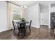 Dining area featuring a round table with chairs and wood flooring at 17087 Wynford Ln, Winter Garden, FL 34787