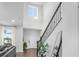 Bright entryway boasts soaring ceilings, dark wood floors, and an elegant staircase with black iron spindles at 17087 Wynford Ln, Winter Garden, FL 34787