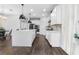 Modern kitchen featuring a large island, stylish pendant lighting, stainless appliances, and custom cabinets at 17087 Wynford Ln, Winter Garden, FL 34787