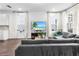 Open living space featuring hardwood floors, a modern sectional, and large windows with natural light at 17087 Wynford Ln, Winter Garden, FL 34787