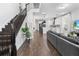 Bright living space with hardwood floors, open staircase, and an open floorplan to the kitchen at 17087 Wynford Ln, Winter Garden, FL 34787