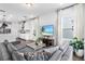 Bright living room featuring sleek furniture, hardwood floors, and an open floor plan at 17087 Wynford Ln, Winter Garden, FL 34787
