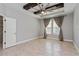 Spacious bedroom with a tray ceiling, fan, and plenty of natural light from two windows at 1720 Benoit Ter, Davenport, FL 33837