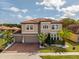 Beautiful two-story home with a three car garage, tiled roof and manicured landscaping at 1720 Benoit Ter, Davenport, FL 33837