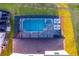 Aerial view of a screened-in pool, jacuzzi, outdoor seating, and well-manicured lawn at 2145 Fleming Mist Pl, Kissimmee, FL 34747