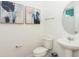 Clean bathroom featuring pedestal sink, modern fixtures and neutral decor at 2145 Fleming Mist Pl, Kissimmee, FL 34747