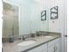 Bathroom featuring double sink vanity, large mirror and shower at 2145 Fleming Mist Pl, Kissimmee, FL 34747