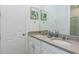 Well-lit bathroom featuring double sinks, neutral countertops, ample cabinet space, and modern fixtures at 2145 Fleming Mist Pl, Kissimmee, FL 34747