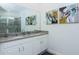 Bathroom with double sinks, vanity, and modern fixtures, along with a glass-enclosed shower at 2145 Fleming Mist Pl, Kissimmee, FL 34747