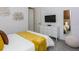 Charming bedroom with a bedspread that matches the blanket, TV, dresser, and modern decor at 2145 Fleming Mist Pl, Kissimmee, FL 34747
