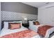 Cozy bedroom with twin beds, decorative headboard, patterned accent wall, and closet at 2145 Fleming Mist Pl, Kissimmee, FL 34747