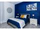 Comfortable bedroom with blue accent wall, soft carpet, and white nightstands at 2145 Fleming Mist Pl, Kissimmee, FL 34747