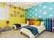 Charming ' bedroom with 'Toy Story' theme, showcasing twin beds, cloud accents, and crayon-inspired decor at 2145 Fleming Mist Pl, Kissimmee, FL 34747