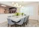 Modern dining room with large table, comfortable seating and contemporary lighting fixtures at 2145 Fleming Mist Pl, Kissimmee, FL 34747