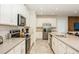 Well-lit kitchen featuring stainless steel appliances, white cabinetry and tile backsplash at 2145 Fleming Mist Pl, Kissimmee, FL 34747