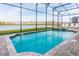 Stunning screened-in pool with lake view and chairs, perfect for relaxation and entertaining at 2145 Fleming Mist Pl, Kissimmee, FL 34747