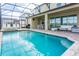 Beautiful screened-in pool with a patio area and outdoor seating, perfect for relaxing at 2145 Fleming Mist Pl, Kissimmee, FL 34747