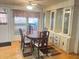 Inviting dining room featuring a wooden table with seating, built-in cabinets, and natural light creating a warm ambiance at 223 Pinewood Dr, Eustis, FL 32726