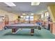 Spacious game room with billiards table, fitness equipment, ample lighting, and lots of space at 223 Pinewood Dr, Eustis, FL 32726