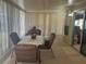 Relaxing enclosed lanai featuring a table with four chairs and neutral carpet, perfect for enjoying the outdoors indoors at 223 Pinewood Dr, Eustis, FL 32726